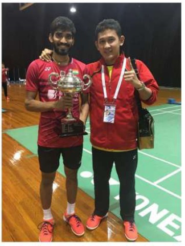 Head Coach Hariawan (right) on court with an international champion and trophy